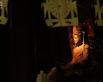 Buddha statue in a dimly lit meditation space