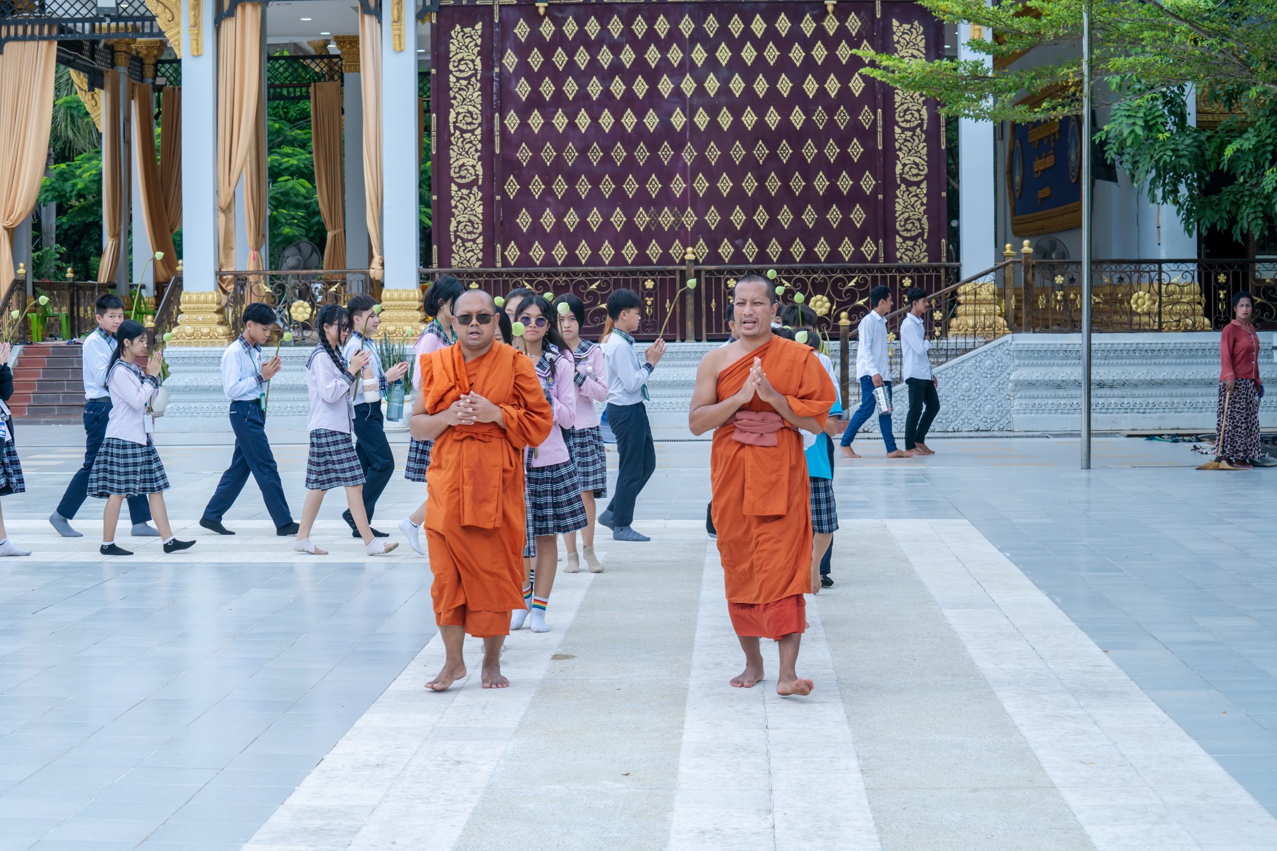 Community members bringing offerings and gathering for a pagoda ceremony